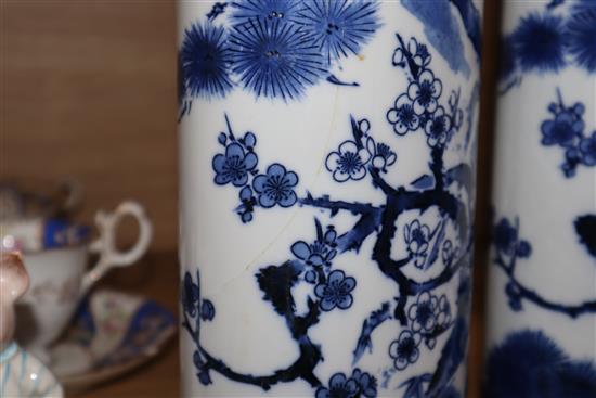 A pair of Chinese blue and white oval section sleeve vases height 25cm (one a.f.)
